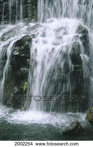 Picture - Hawaii, Maui, Fast Moving Waterfall Over Rocks, Along Road To Hana. Fotosearch