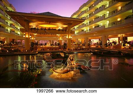 Stock Photograph - Hawaii, Maui, Grand Wailea Resort, Illuminated Mermaid Statue, Twilight A49C. Fotosearch