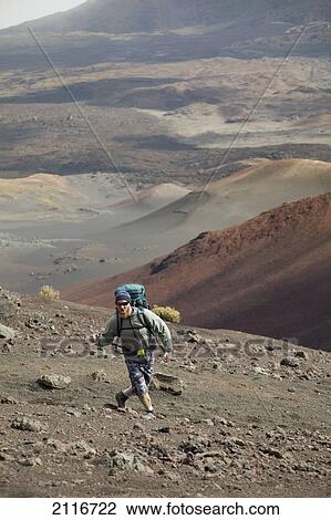 Stock Image - Hawaii, Maui, Haleakala Crater, A hiker has fun along the trail.. Fotosearch