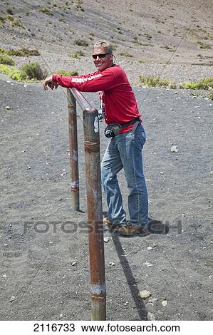 Stock Image - Hawaii, Maui, Haleakala Crater, A hiker rests along the trail.. Fotosearch
