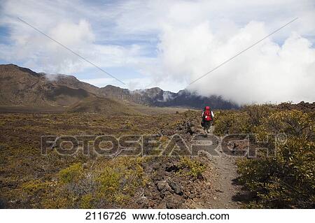 Hawaii, Maui, Haleakala Crater, A hiker trekking through the crater. View Large Photo Image Stock Photograph - Hawaii, Maui, Haleakala Crater, A hiker trekking through the crater.. Fotosearch