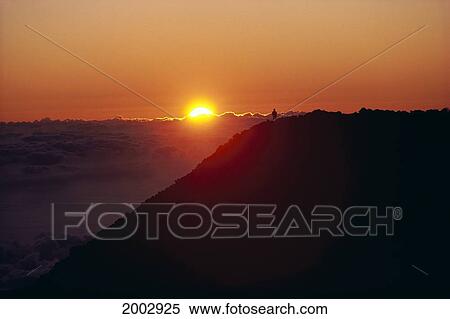 Hawaii, Maui, Haleakala Crater, At Sunrise With Pink Orange Skies Over Clouds, Silhouetted Man View Large Photo Image Stock Photography - Hawaii, Maui, Haleakala Crater, At Sunrise With Pink Orange Skies Over Clouds, Silhouetted Man. Fotosearch