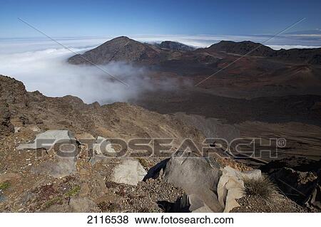 Stock Photo - Hawaii, Maui, Haleakala Crater, Clouds rolling into the crater.. Fotosearch