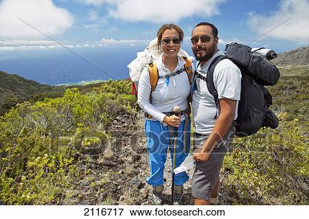 Stock Photo - Hawaii, Maui, Haleakala Crater, Two hikers stop and smile while hiking Kaupo Gap.. Fotosearch