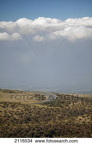 Picture - Hawaii, Maui, Haleakala, Road beneath a large vog cloud.. Fotosearch