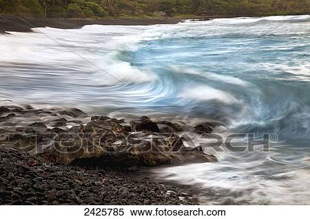Hawaii, Maui, Hana, A soft slow view of ocean waves crashing on black lava rock View Large Photo Image Stock Photography - Hawaii, Maui, Hana, A soft slow view of ocean waves crashing on black lava rock. Fotosearch