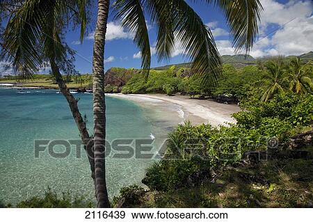 Stock Photo - Hawaii, Maui, Hana, A sunny view of Hamoa Beach with clear ocean on a calm day.. Fotosearch