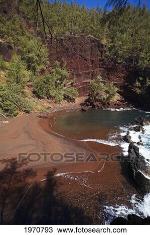 Stock Image - Hawaii, Maui, Hana, Kaihalulu Beach, Scenic Shot Of Hana's Red Sand Beach, Tourists On Beach.. Fotosearch