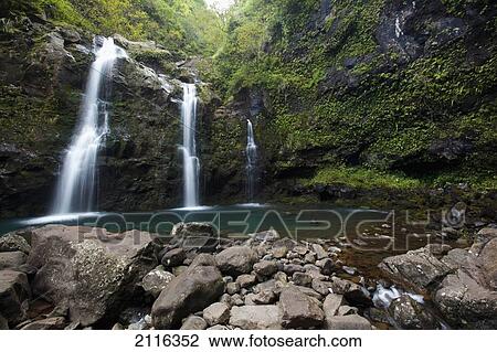 Stock Image - Hawaii, Maui, Hana, The three Waikani Falls with a clear blue pond on The Road To Hana. Fotosearch