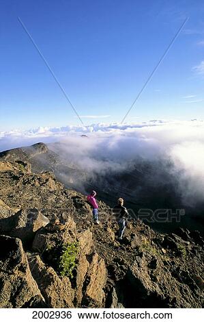 Hawaii, Maui, Hikers At Top Of Haleakala Crater, Blue Sky, White Clouds View Large Photo Image Stock Photograph - Hawaii, Maui, Hikers At Top Of Haleakala Crater, Blue Sky, White Clouds. Fotosearch