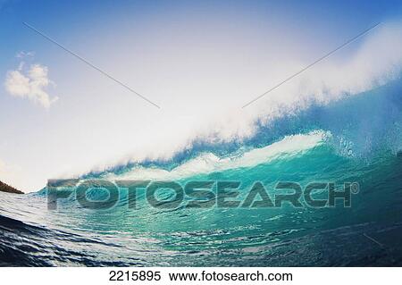 Stock Photography - Hawaii, Maui, Honolua Bay, Beautiful blue wave at sunset.. Fotosearch