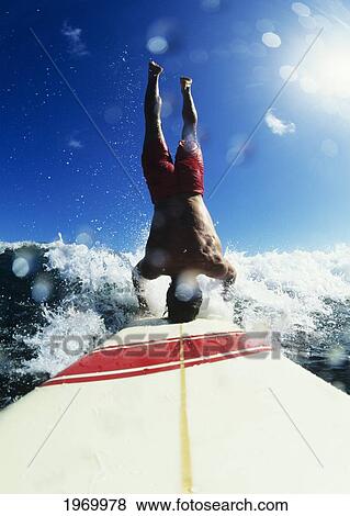 Stock Photo - Hawaii, Maui, Hookipa, Buzzy Kerbox Riding A Wave While Doing A Headstand.. Fotosearch