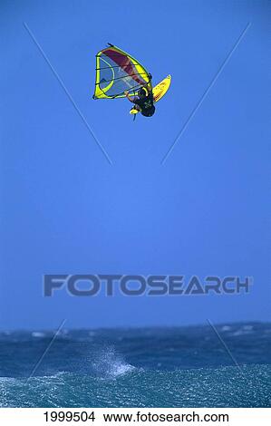 Picture - Hawaii, Maui, Ho'okipa, Distant View Of Jason Polakow In Blue Skies, Airborne. Fotosearch