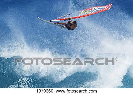 Stock Image - Hawaii, Maui, Ho'okipa, Professional Windsurfer Ricardo Campello Catches Big Air Off Wave. For Editorial Use Only.. Fotosearch