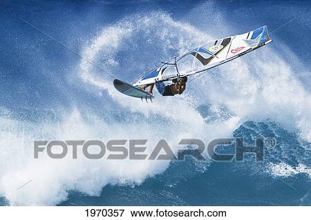Stock Photo - Hawaii, Maui, Ho'okipa, Professional Windsurfer Marcilio Browne Catches Big Air Off Wave. For Editorial Use Only.. Fotosearch