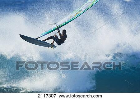 Stock Photo - Hawaii, Maui, Ho'okipa, Professional windsurfer Kauli Seadi catches big air. EDITORIAL USE ONLY.. Fotosearch
