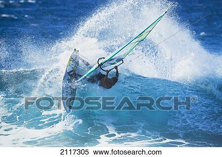 Stock Photography - Hawaii, Maui, Ho'okipa, Professional windsurfer Kauli Seadi carves a powerful turn on a wave. EDITORIAL USE ONLY.. Fotosearch