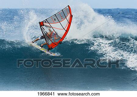 Stock Image - Hawaii, Maui, Ho'okipa, Windsurfer Carves Big Turn On Large Wave. Fotosearch