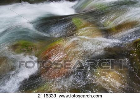 Stock Photo - Hawaii, Maui, Iao Valley, A close up of colorful river rocks under water.. Fotosearch