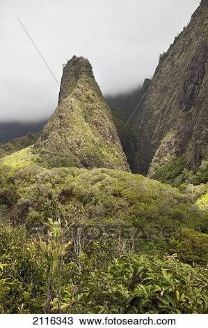 Stock Image - Hawaii, Maui, Iao Valley, A view of Iao Needle among misty clouds.. Fotosearch
