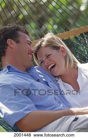 Stock Photo - Hawaii, Maui, Ka'anapali, Caucasian Couple In Hammock Smiling Face Each Other, Outdoor D1119. Fotosearch