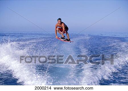 Picture - Hawaii, Maui, Ka'anapali, Lahaina Man Wakeboarding Jumping In Air, Calm Ocean Horizon. Fotosearch