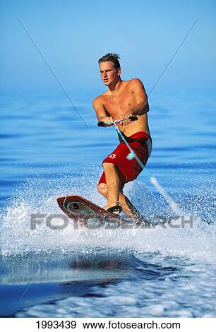 Stock Photo - Hawaii, Maui, Kaanapali, Man Wakeboarding Holds On To Tow Rope. Fotosearch