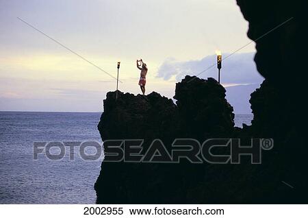 Stock Photography - Hawaii, Maui, Ka'anapali, Torch Lighting, Black Rock, Silhouettes, Ocean Beyond. Fotosearch