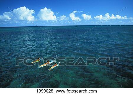 Stock Photo - Hawaii, Maui, Kanaha, Three Women On Surfboards Paddling Out. Fotosearch