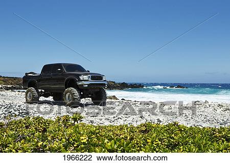 Stock Image - Hawaii, Maui, Kanaio Coast, Lifted Off Road Truck Along Ocean. Editorial Use Only.. Fotosearch