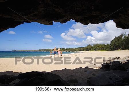 Stock Photo - Hawaii, Maui, Kapalua, Fleming Beach, Family On Vacation Walking Down The Beach, View From Seacave. Fotosearch