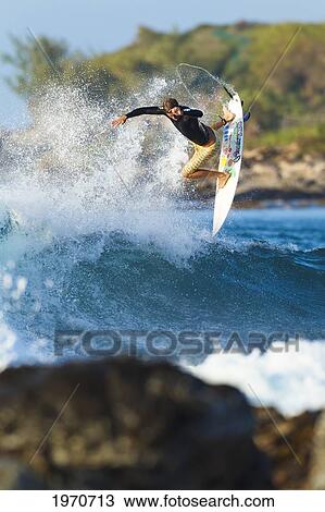 Stock Image - Hawaii, Maui, Kapalua, Professional Surfer Albee Layer Catches Air Off A Wave. For Editorial Use Only.. Fotosearch