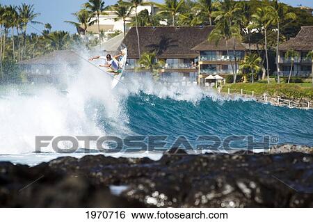 Stock Photograph - Hawaii, Maui, Kapalua, Professional Surfer Albee Layer Catches Air Off A Wave. For Editorial Use Only.. Fotosearch