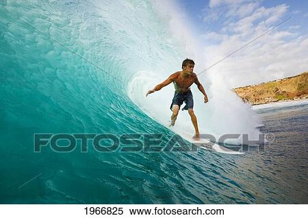 Stock Photography - Hawaii, Maui, Kapalua, Surfer Tides Perfect Wave At Honolua Bay, View From Water Level Into The Barrel. Fotosearch