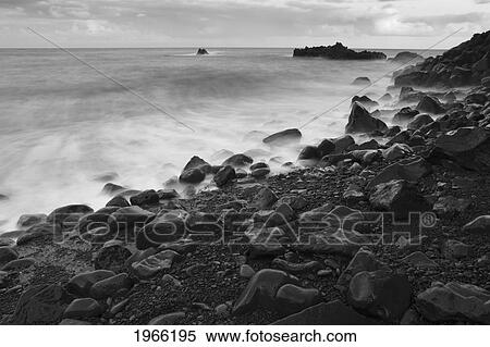Hawaii, Maui, Kaupo, Rocky Ocean Shoreline At Evening, Long Exposure, Black And White Photograph. View Large Photo Image Stock Photography - Hawaii, Maui, Kaupo, Rocky Ocean Shoreline At Evening, Long Exposure, Black And White Photograph.. Fotosearch