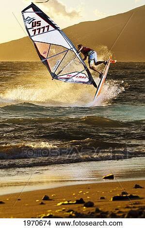 Picture - Hawaii, Maui, Kihei, Professional Windsurfer Dean Christener Sailing At Sunset. For Editorial Use Only.. Fotosearch