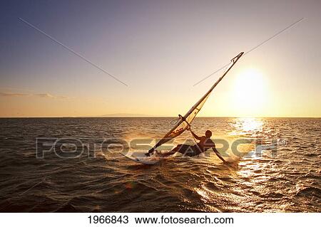 Hawaii, Maui, Kihei, Windsurfer Sailing Off The Coast Of South Maui At Sunset. View Large Photo Image Stock Image - Hawaii, Maui, Kihei, Windsurfer Sailing Off The Coast Of South Maui At Sunset.. Fotosearch