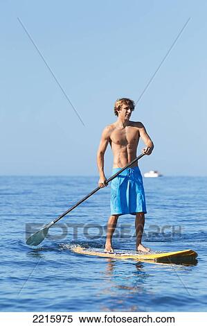 Hawaii, Maui, Kihei, Young man Stand Up Paddling in the ocean on sunny day. View Large Photo Image Stock Photography - Hawaii, Maui, Kihei, Young man Stand Up Paddling in the ocean on sunny day.. Fotosearch