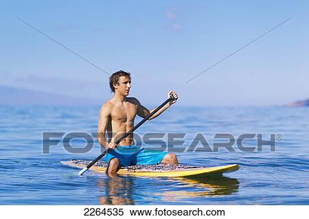 Stock Photography - Hawaii, Maui, Kihei, Young Man Stand Up Paddling In The Ocean On Sunny Day.. Fotosearch