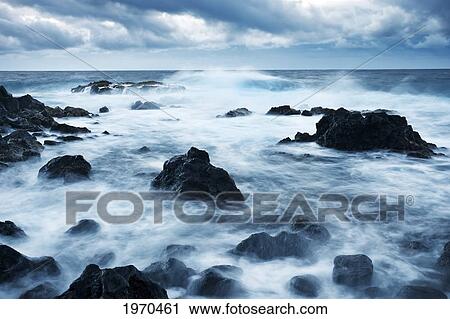 Stock Image - Hawaii, Maui, Kipahulu, Dramatic Stormy Ocean Coastline At Sunrise. Fotosearch