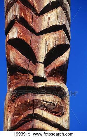 Stock Photography - Hawaii, Maui, Lahaina Center, Hale Kahiko, Closeup Of Wooden Handcarved Tiki, Blue Sky Background. Fotosearch