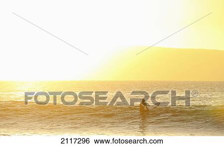 Hawaii, Maui, Lahina, Surfer waiting for wave at sunset. EDITORIAL USE ONLY. View Large Photo Image Stock Photograph - Hawaii, Maui, Lahina, Surfer waiting for wave at sunset. EDITORIAL USE ONLY.. Fotosearch