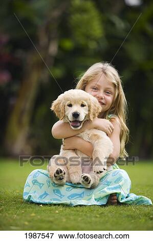 Hawaii, Maui, Little Girl Sits On Grass Holding A Golden Retriever Puppy. View Large Photo Image Stock Photo - Hawaii, Maui, Little Girl Sits On Grass Holding A Golden Retriever Puppy.. Fotosearch