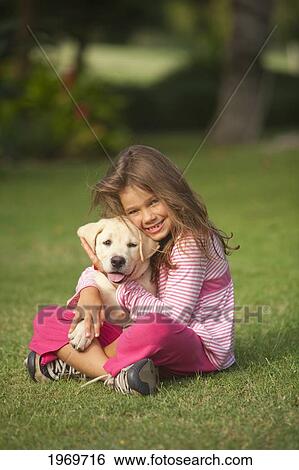 Hawaii, Maui, Little Girl Sits On Grass Holding A Golden Retriever Puppy. View Large Photo Image Stock Photograph - Hawaii, Maui, Little Girl Sits On Grass Holding A Golden Retriever Puppy.. Fotosearch