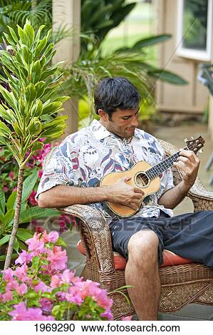 Stock Image - Hawaii, Maui, Local Male Playing An Ukulele.. Fotosearch