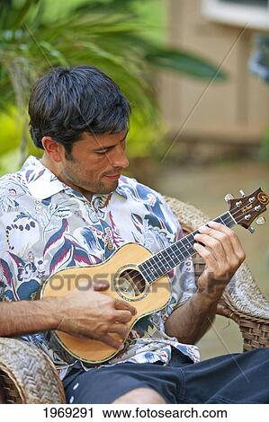 Stock Image - Hawaii, Maui, Local Male Playing An Ukulele.. Fotosearch