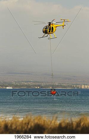Picture - Hawaii, Maui, Ma'alaea, Fire Helicopter Collecting Ocean Water To Help Put Out Wildfire. Editorial Use Only.. Fotosearch