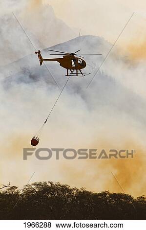 Hawaii, Maui, Ma'alaea, Fire Helicopter Dropping Ocean Water On Wildfire. Editorial Use Only. View Large Photo Image Stock Photo - Hawaii, Maui, Ma'alaea, Fire Helicopter Dropping Ocean Water On Wildfire. Editorial Use Only.. Fotosearch