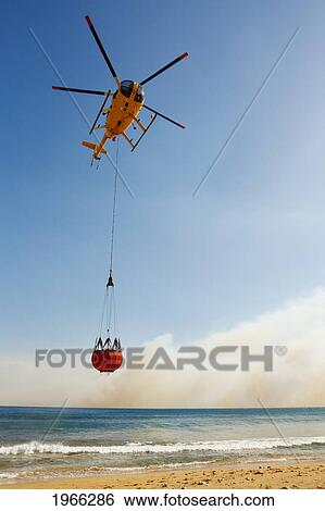 Hawaii, Maui, Ma'alaea, Fire Helicopter Collecting Ocean Water To Help Put Out Wildfire. Editorial Use Only. View Large Photo Image Stock Photograph - Hawaii, Maui, Ma'alaea, Fire Helicopter Collecting Ocean Water To Help Put Out Wildfire. Editorial Use Only.. Fotosearch