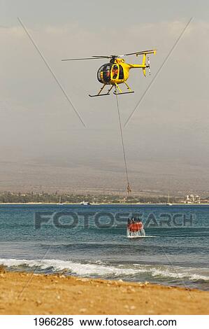 Stock Photography - Hawaii, Maui, Ma'alaea, Fire Helicopter Collecting Ocean Water To Help Put Out Wildfire. Editorial Use Only.. Fotosearch